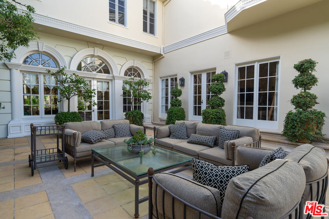 722 North Elm Drive Beverly Hills, CA 90210 - Photo 48 of 51 a view of a patio with couches a fire pit and a potted plant