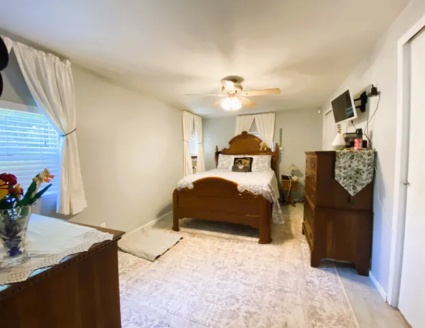 a bedroom with a large bed and a chandelier