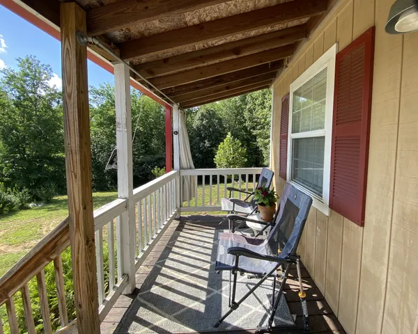 a view of a balcony with chair and floor to ceiling window