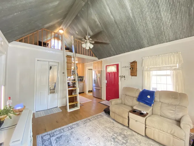 a living room with furniture a dining table and a couch