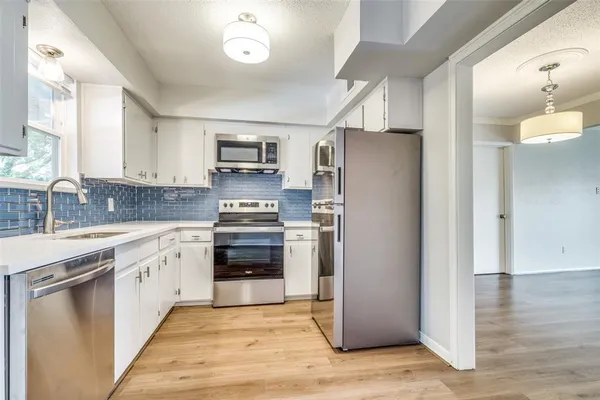 a kitchen with a refrigerator stove and sink