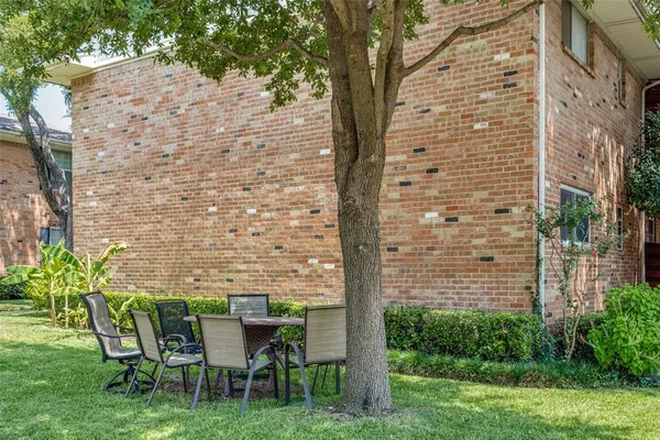 a backyard of a house with table and chairs