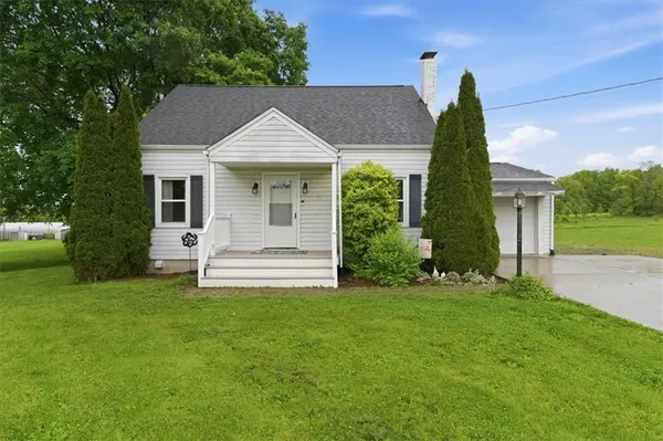 a view of a house with a yard and sitting area