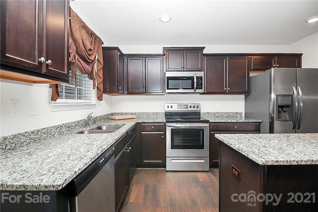 8036 Starnes Randall Road Charlotte, NC 28215 - Photo 12 of 45 a kitchen with granite countertop stainless steel appliances and sink