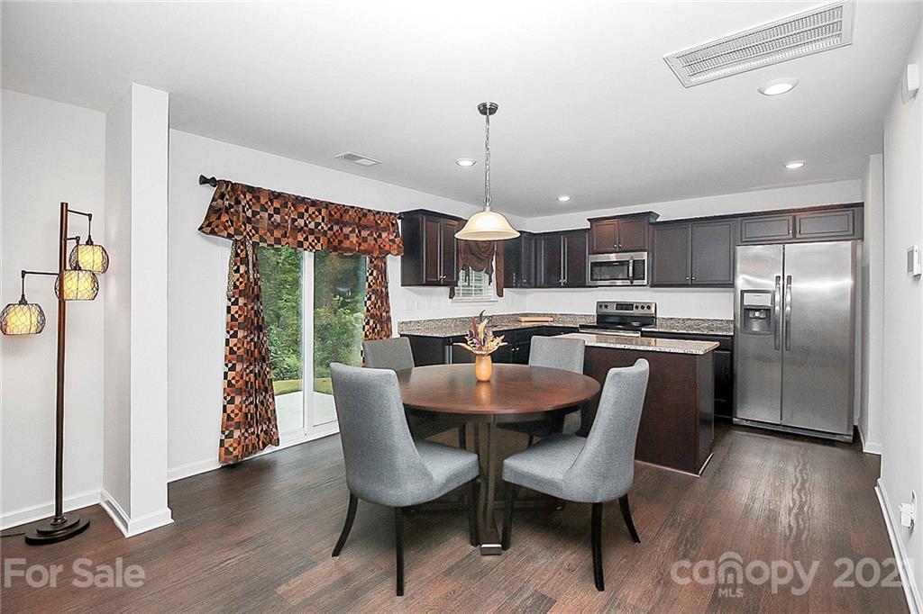 8036 Starnes Randall Road Charlotte, NC 28215 - Photo 14 of 45 a view of a dining room with furniture window and wooden floor