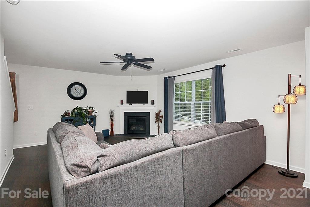 8036 Starnes Randall Road Charlotte, NC 28215 - Photo 16 of 45 a living room with furniture a fireplace and a window
