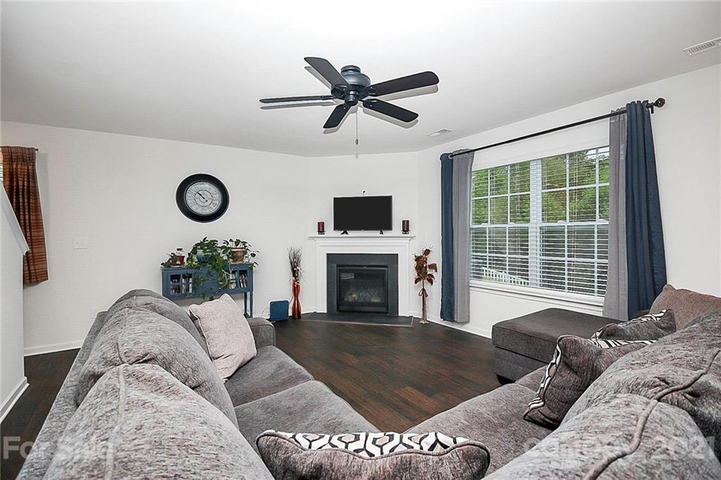 8036 Starnes Randall Road Charlotte, NC 28215 - Photo 17 of 45 a living room with furniture a fireplace and a flat screen tv