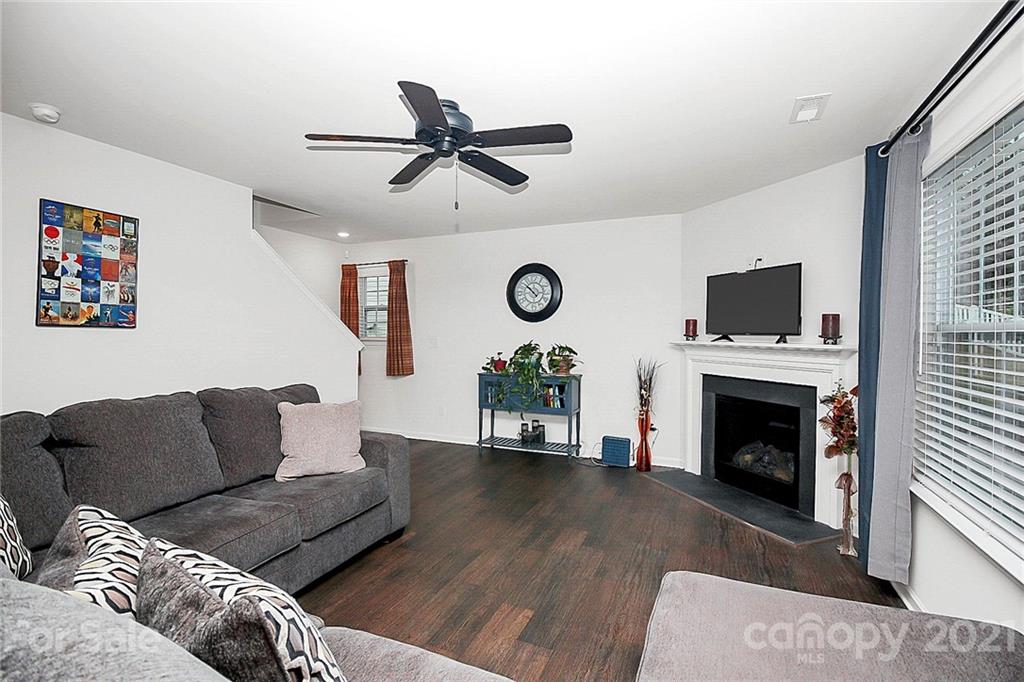 8036 Starnes Randall Road Charlotte, NC 28215 - Photo 18 of 45 a living room with furniture a fireplace and a flat screen tv