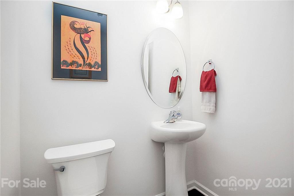 8036 Starnes Randall Road Charlotte, NC 28215 - Photo 21 of 45 a bathroom with a sink mirror and toilet