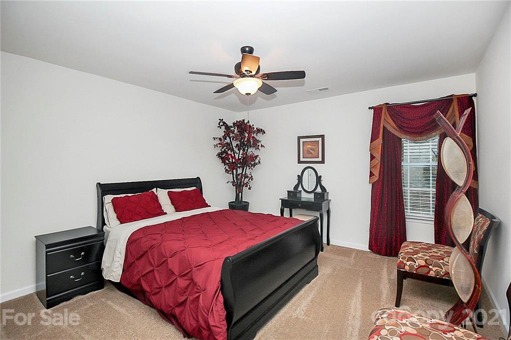 8036 Starnes Randall Road Charlotte, NC 28215 - Photo 22 of 45 a bedroom with bed and a chandelier