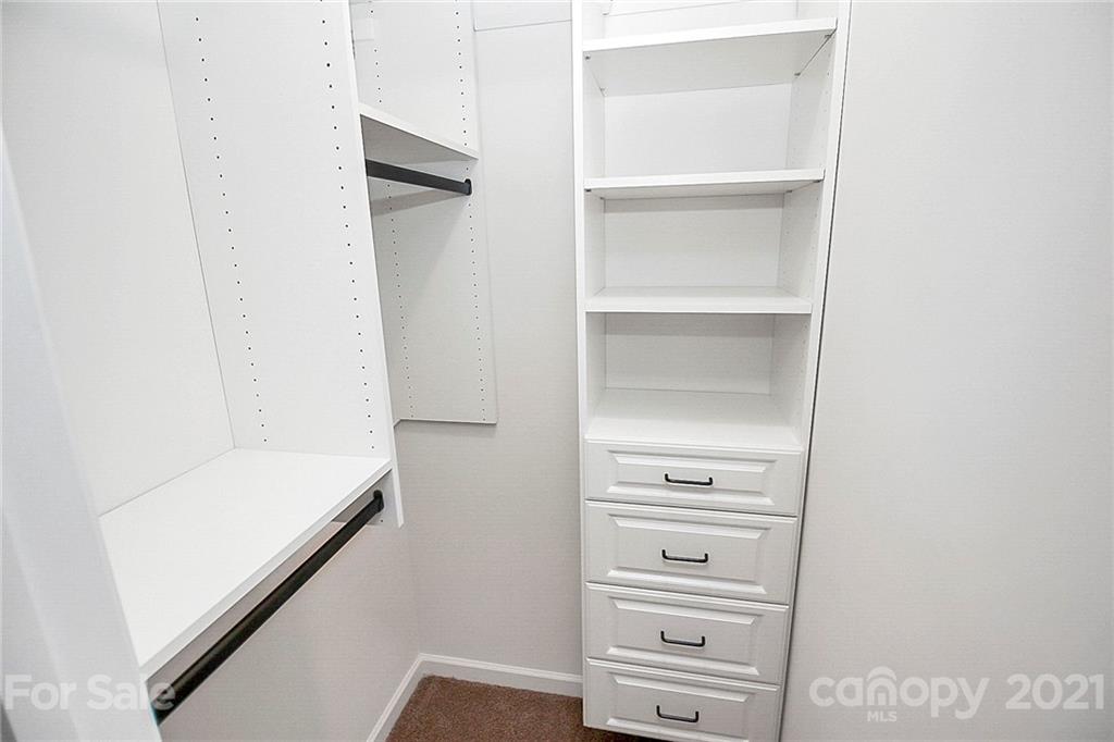 8036 Starnes Randall Road Charlotte, NC 28215 - Photo 24 of 45 a view of walk in closet with empty racks