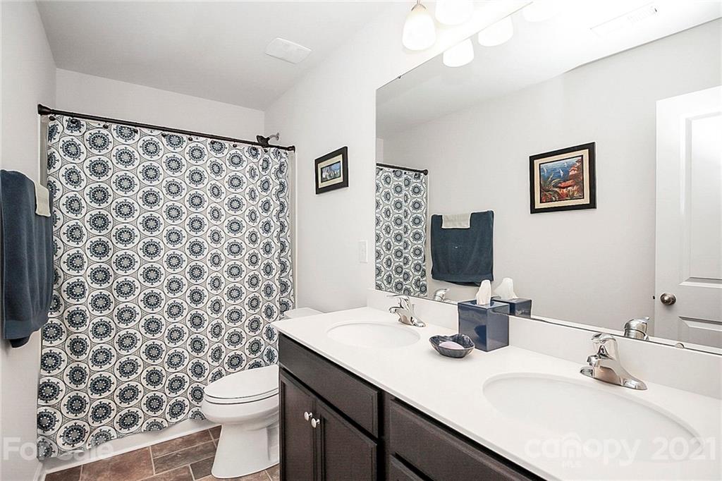 8036 Starnes Randall Road Charlotte, NC 28215 - Photo 27 of 45 a bathroom with a sink toilet and shower