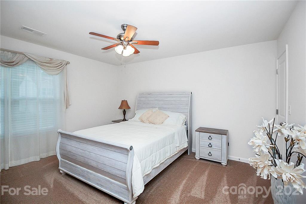 8036 Starnes Randall Road Charlotte, NC 28215 - Photo 29 of 45 a bedroom with a bed and a chandelier