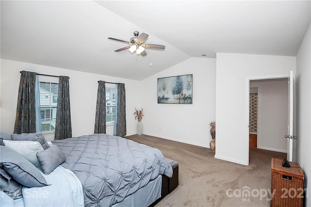 8036 Starnes Randall Road Charlotte, NC 28215 - Photo 34 of 45 a bedroom with a large bed and a chandelier