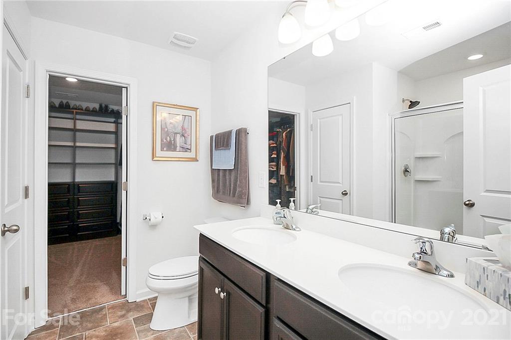 8036 Starnes Randall Road Charlotte, NC 28215 - Photo 35 of 45 a bathroom with a sink a toilet a shower and a mirror