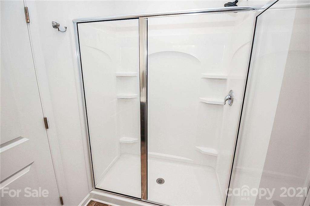 8036 Starnes Randall Road Charlotte, NC 28215 - Photo 36 of 45 a bathroom with a glass shower door