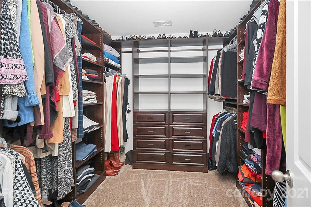 8036 Starnes Randall Road Charlotte, NC 28215 - Photo 38 of 45 a view of walk in closet with clothes and shoes
