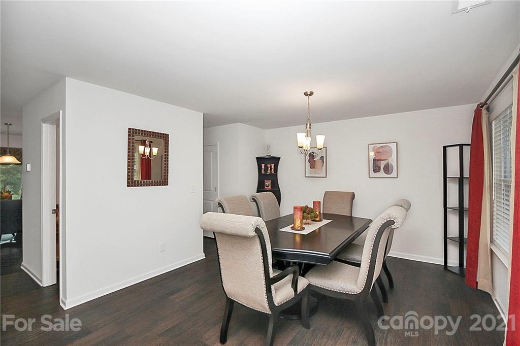 8036 Starnes Randall Road Charlotte, NC 28215 - Photo 6 of 45 a view of a dining room with furniture and wooden floor
