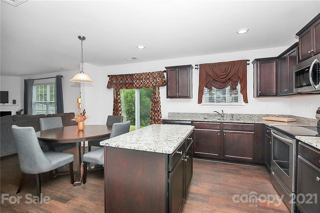 8036 Starnes Randall Road Charlotte, NC 28215 - Photo 9 of 45 a kitchen with a stove a sink and a refrigerator