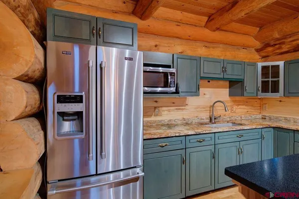 an aerial view of a house with swimming pool and a yard