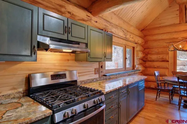 a living room with furniture a flat screen tv and a floor to ceiling window