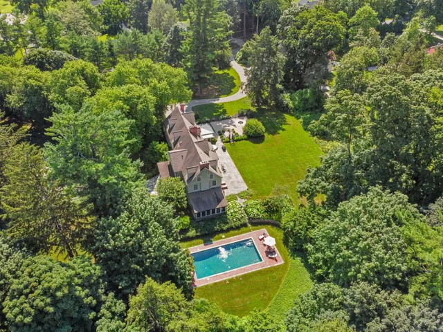an aerial view of residential house with outdoor space and swimming pool