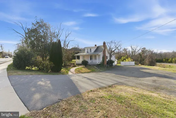 a view of large house with a yard and a large tree