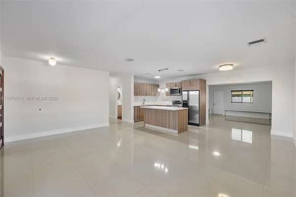 a view of a kitchen with furniture and a window