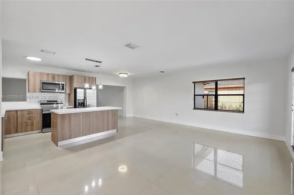 a kitchen with stainless steel appliances a refrigerator and a stove top oven