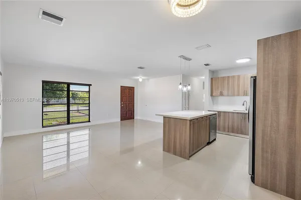 a large white kitchen with a large window