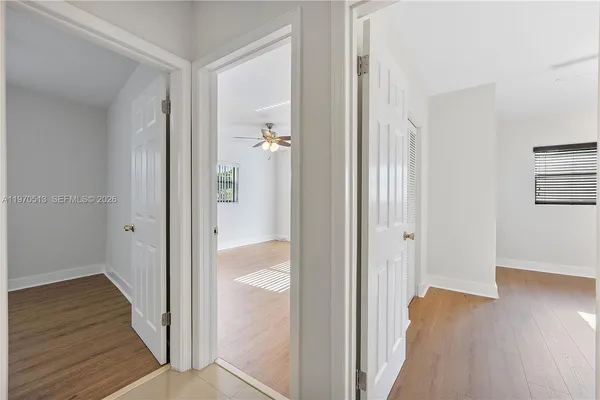 a view of a hallway with wooden floor