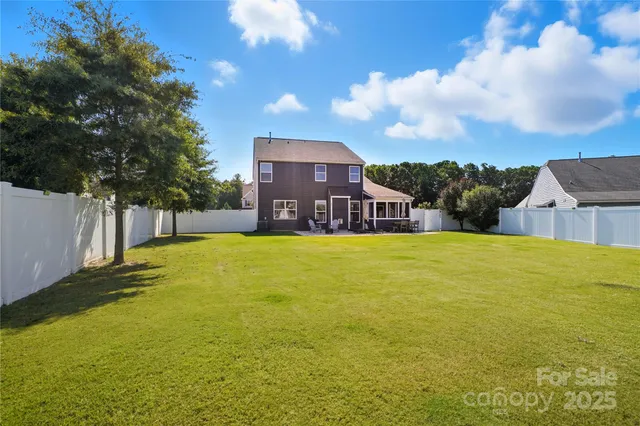 a kitchen with kitchen island granite countertop stainless steel appliances cabinets a sink and a counter top space