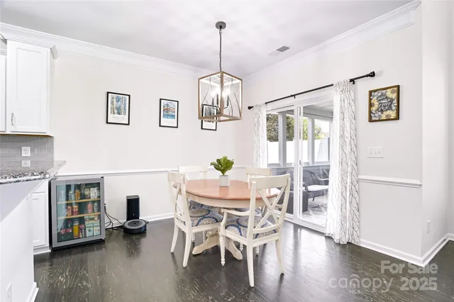 a kitchen with white cabinets appliances and a sink