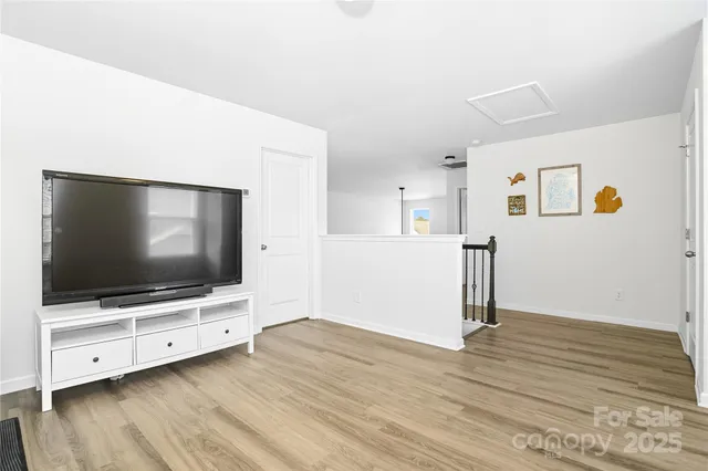 a bedroom with a bed chair and a potted plant