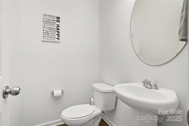 a dining room with furniture a chandelier and wooden floor