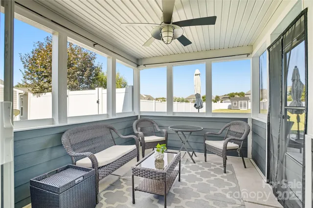 a view of a terrace with lawn chairs
