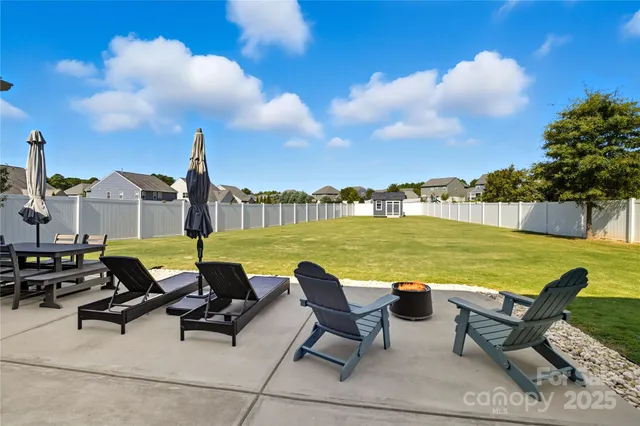 a view of a house with backyard outdoor seating area and barbeque oven