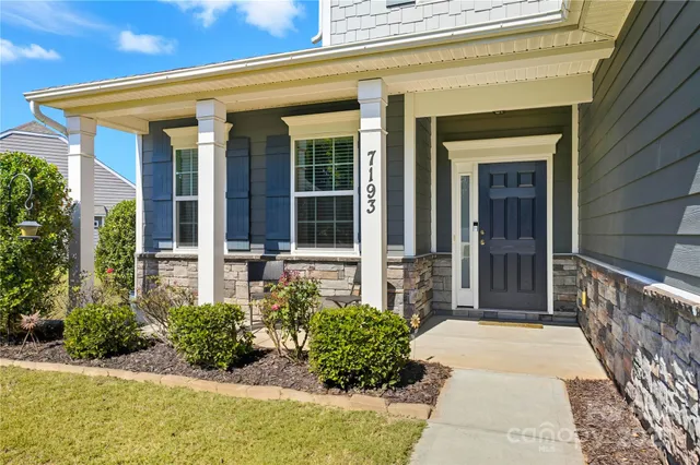 a view of a hallway with wooden floor and stairs