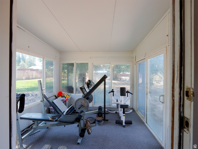 270 East 100 North Monroe, UT 84754 - Photo 13 of 65 Enclosed sunroom featuring multiple large windows, a sliding glass door, and carpeted flooring