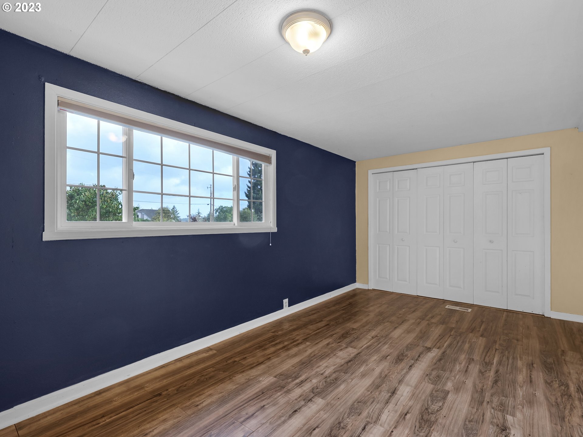 92287 Walluski Loop Astoria, OR 97103 - Photo 13 of 39 a view of empty room with wooden floor and fan
