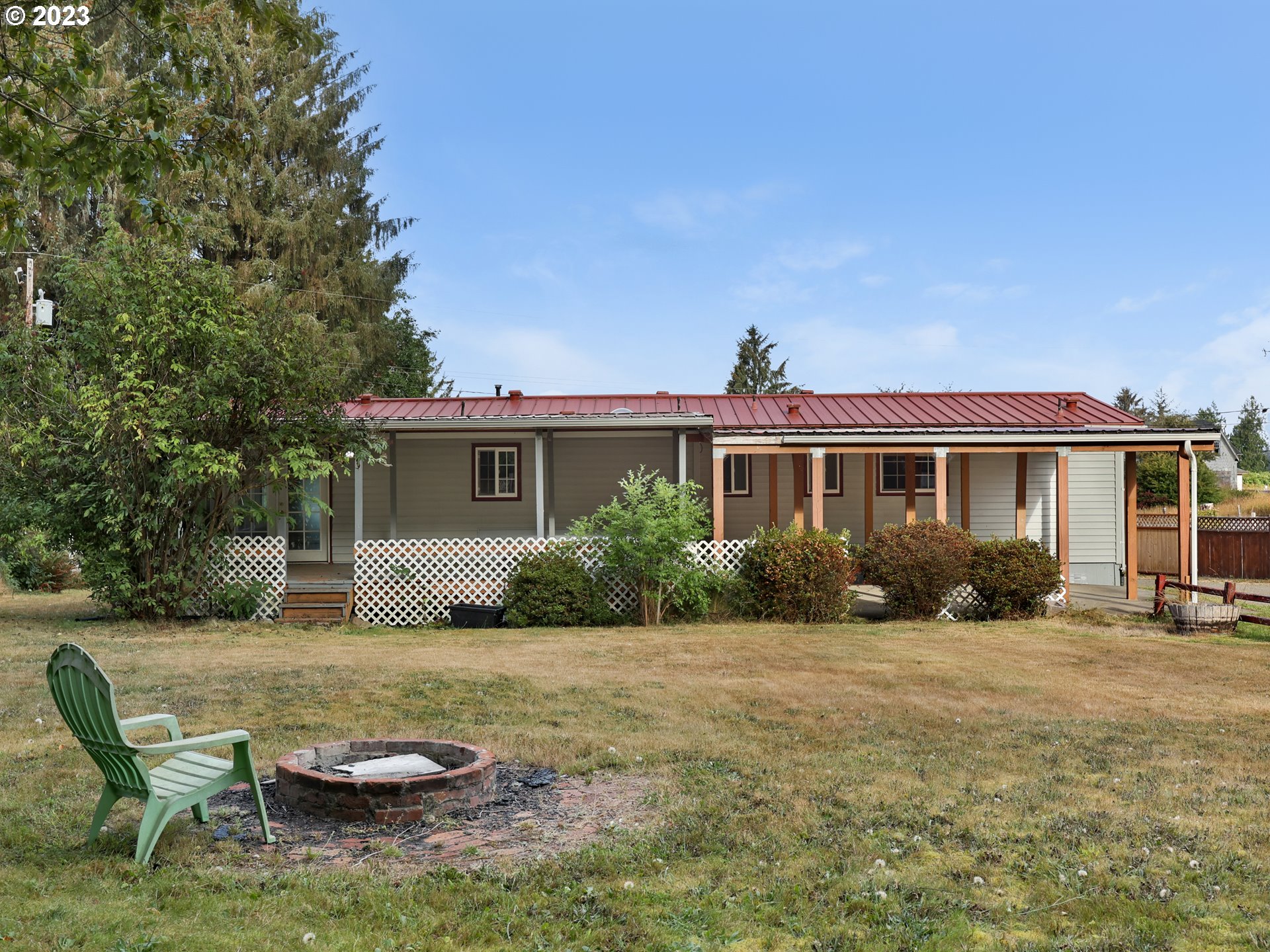 92287 Walluski Loop Astoria, OR 97103 - Photo 24 of 39 a view of a house with backyard sitting area and garden