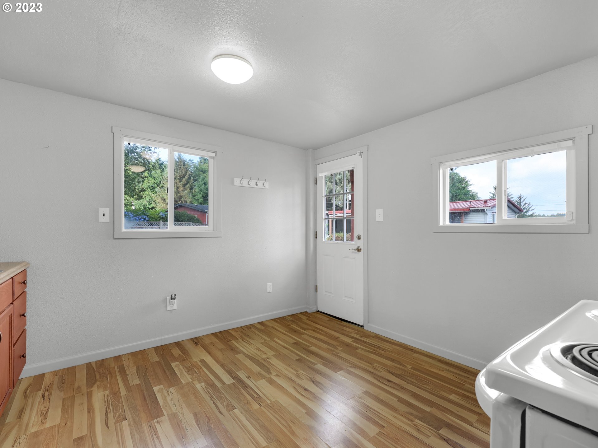 92287 Walluski Loop Astoria, OR 97103 - Photo 28 of 39 a view of empty room with wooden floor and fan
