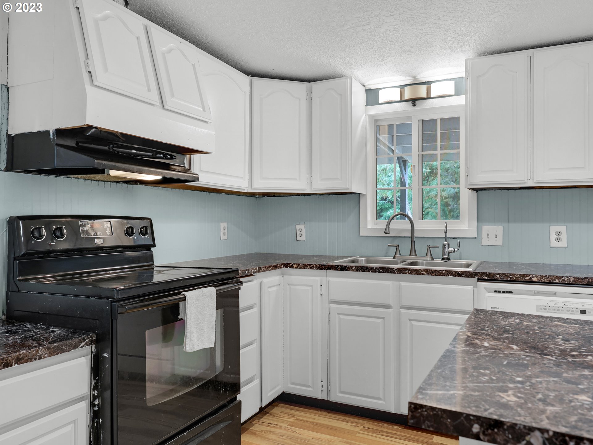 92287 Walluski Loop Astoria, OR 97103 - Photo 4 of 39 a kitchen with granite countertop cabinets stainless steel appliances and a sink