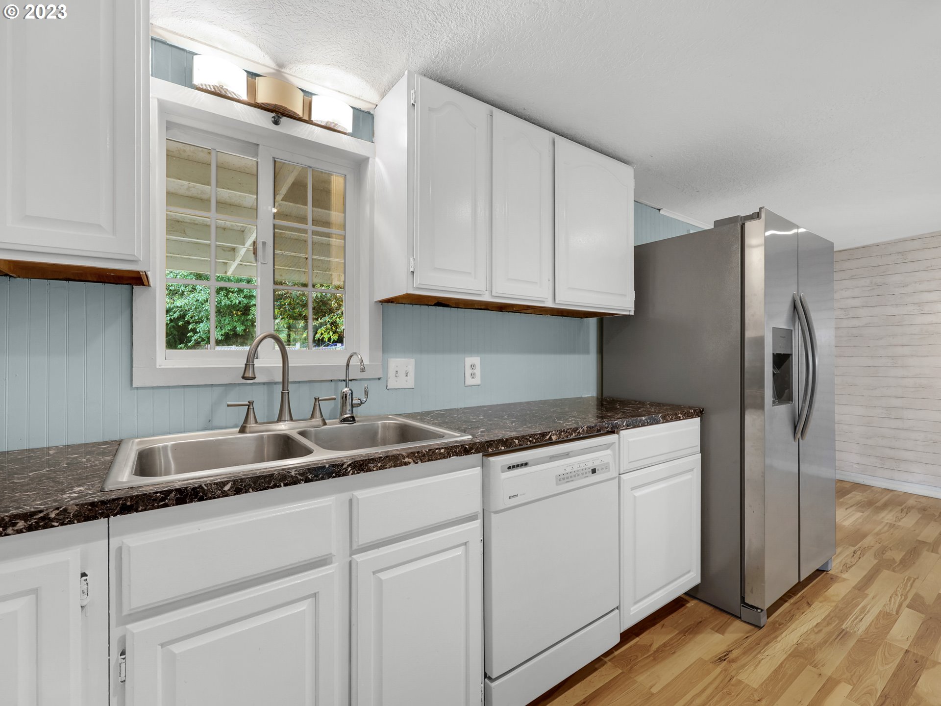 92287 Walluski Loop Astoria, OR 97103 - Photo 5 of 39 a kitchen with stainless steel appliances granite countertop a sink and a refrigerator