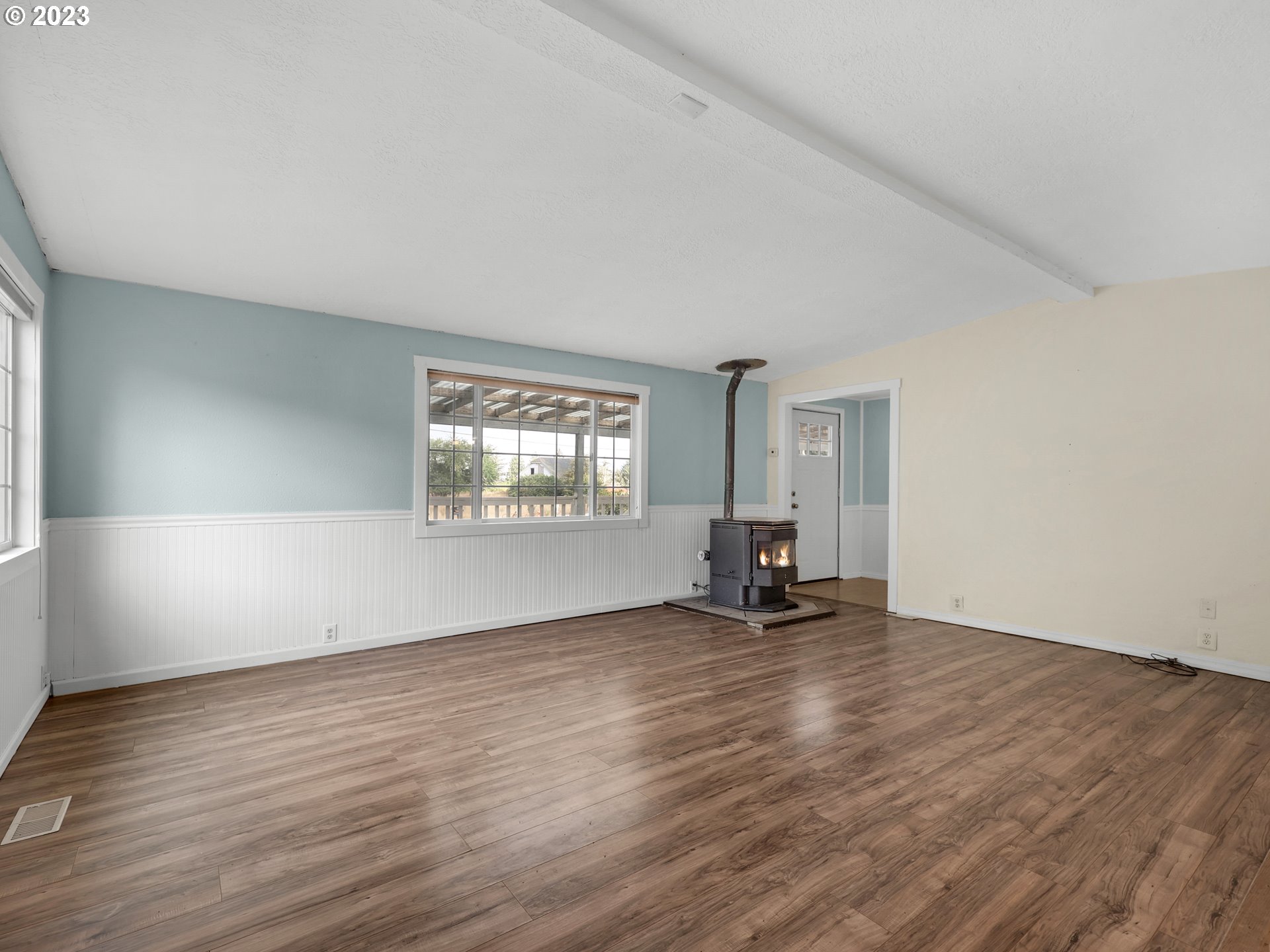 92287 Walluski Loop Astoria, OR 97103 - Photo 6 of 39 an empty room with wooden floor and windows