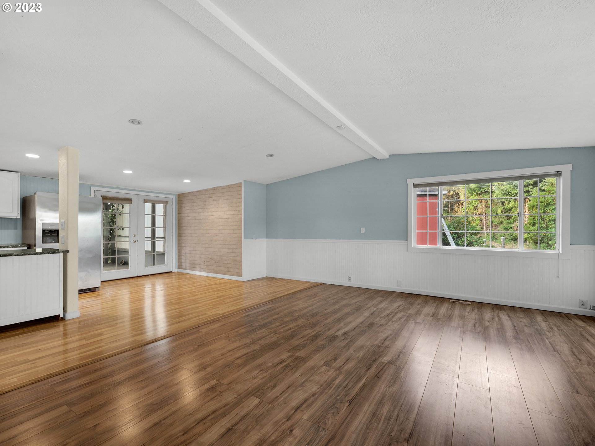 92287 Walluski Loop Astoria, OR 97103 - Photo 9 of 39 a view of an empty room with wooden floor and a window