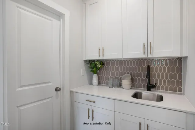 a kitchen with stainless steel appliances granite countertop a stove a sink a refrigerator a microwave a dining table and chairs with wooden floor