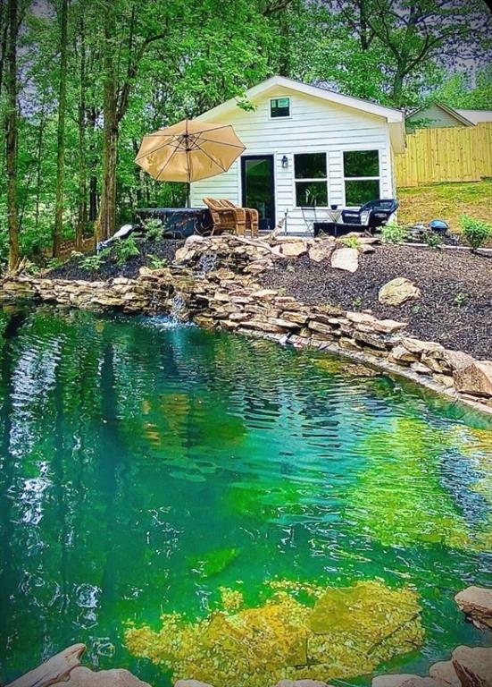 710 Lumber Company Road Talking Rock, GA 30175 - Photo 1 of 27 a view of a house with pool and chairs