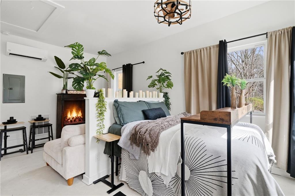 710 Lumber Company Road Talking Rock, GA 30175 - Photo 12 of 27 a bedroom with a bed and a potted plant