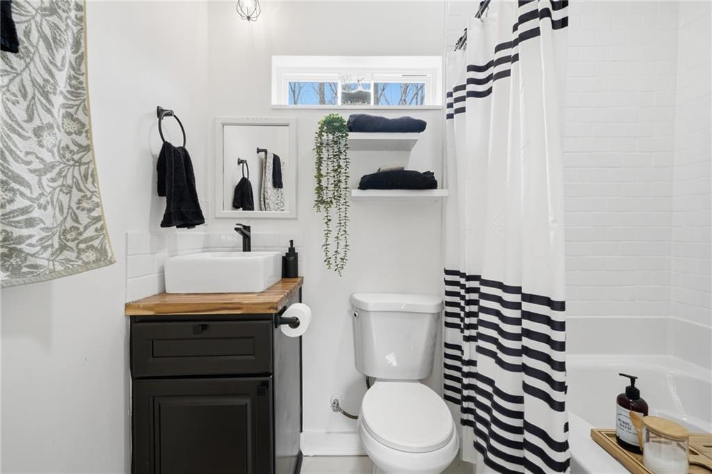 710 Lumber Company Road Talking Rock, GA 30175 - Photo 18 of 27 a white toilet sitting next to a bathroom sink